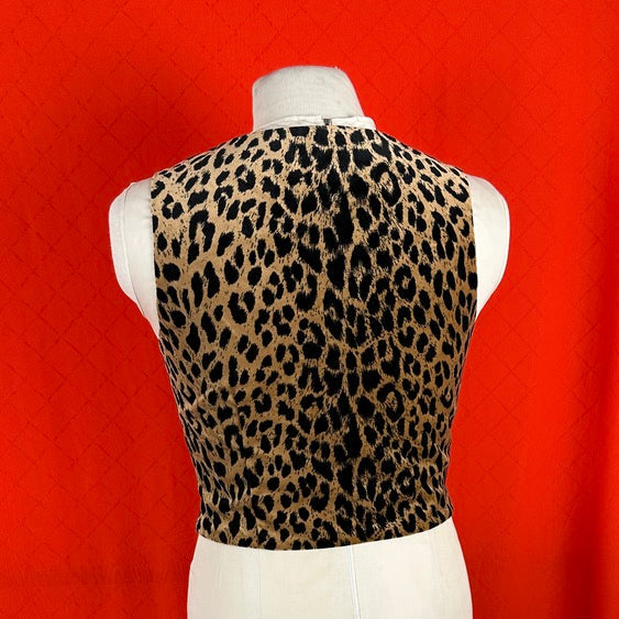 Leopard print top on a mannequin against a red background